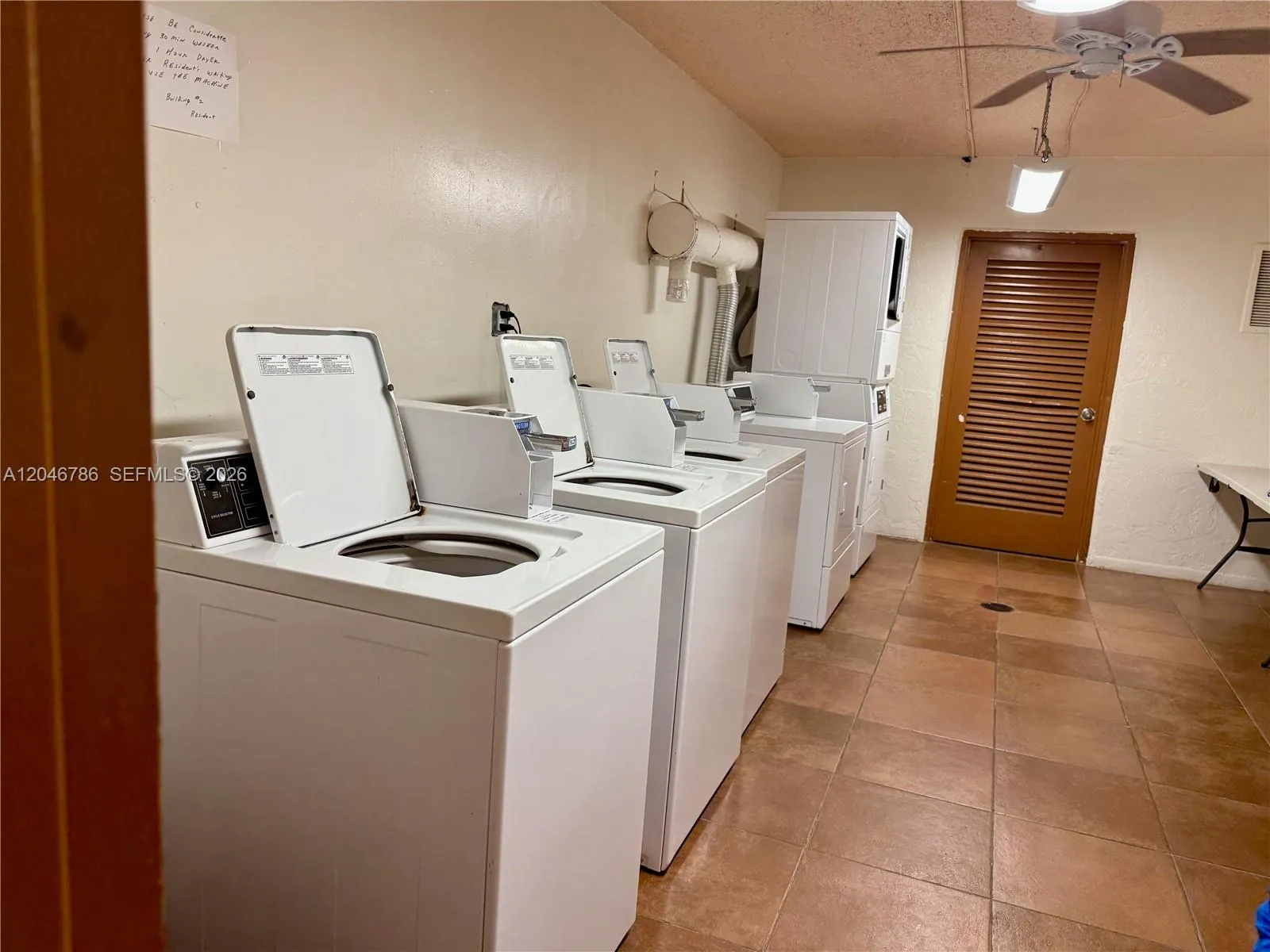 Clean and large laundry room with folding tables