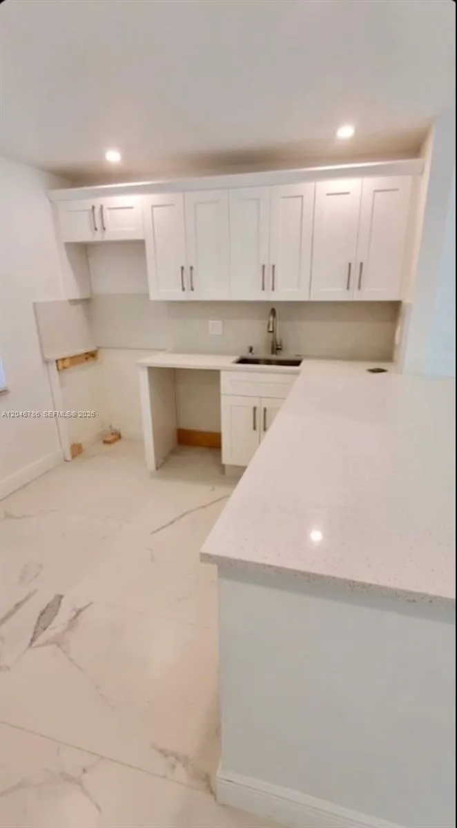 Stocked with stainless steel appliances including a French door refrigerator.