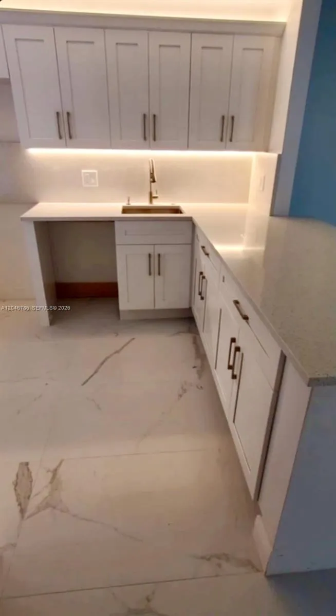 Stocked with stainless steel appliances including a French door refrigerator.