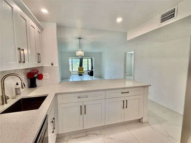 Stocked with stainless steel appliances including a French door refrigerator.