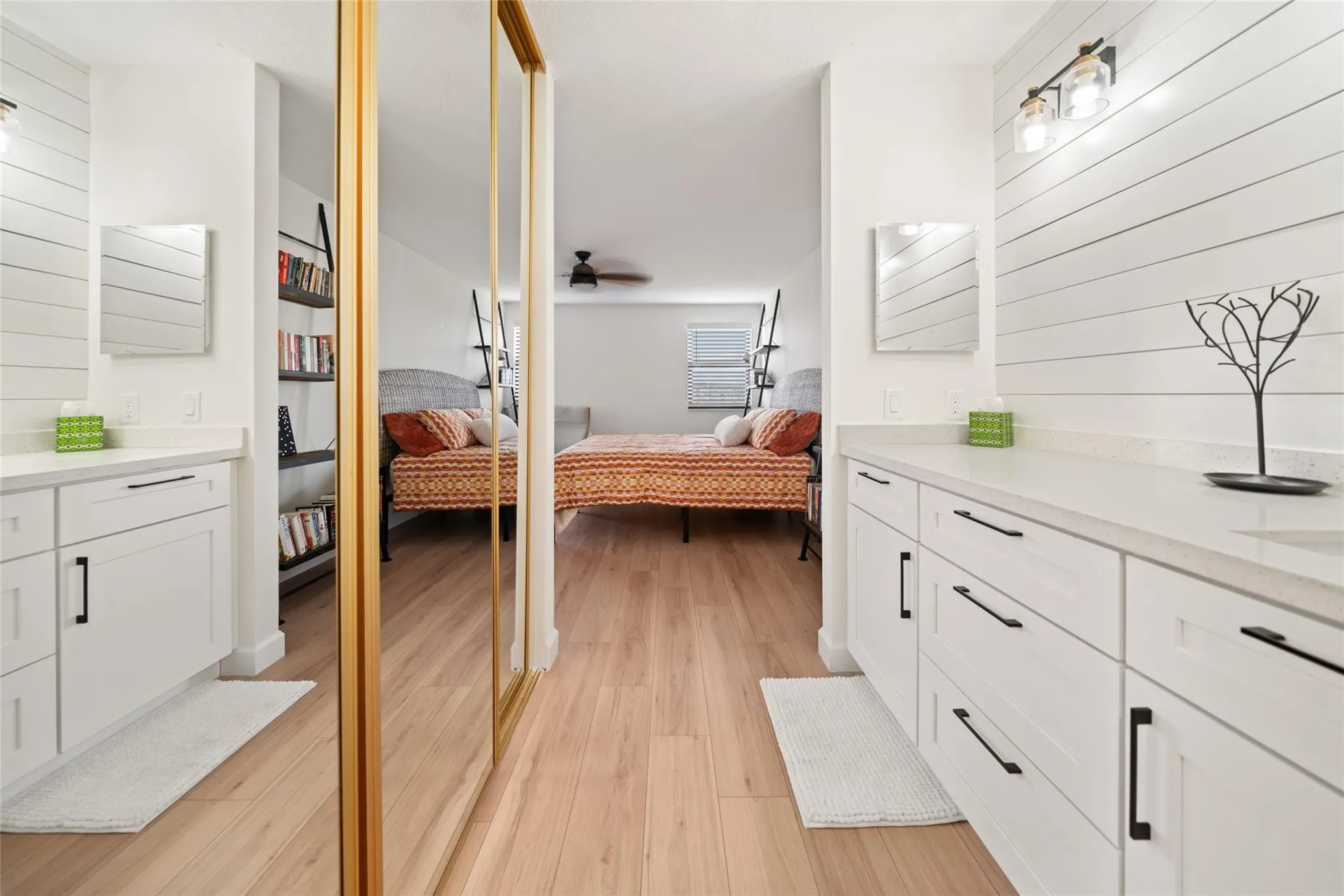 Primary dressing area leading into walk-in closet and bathroom