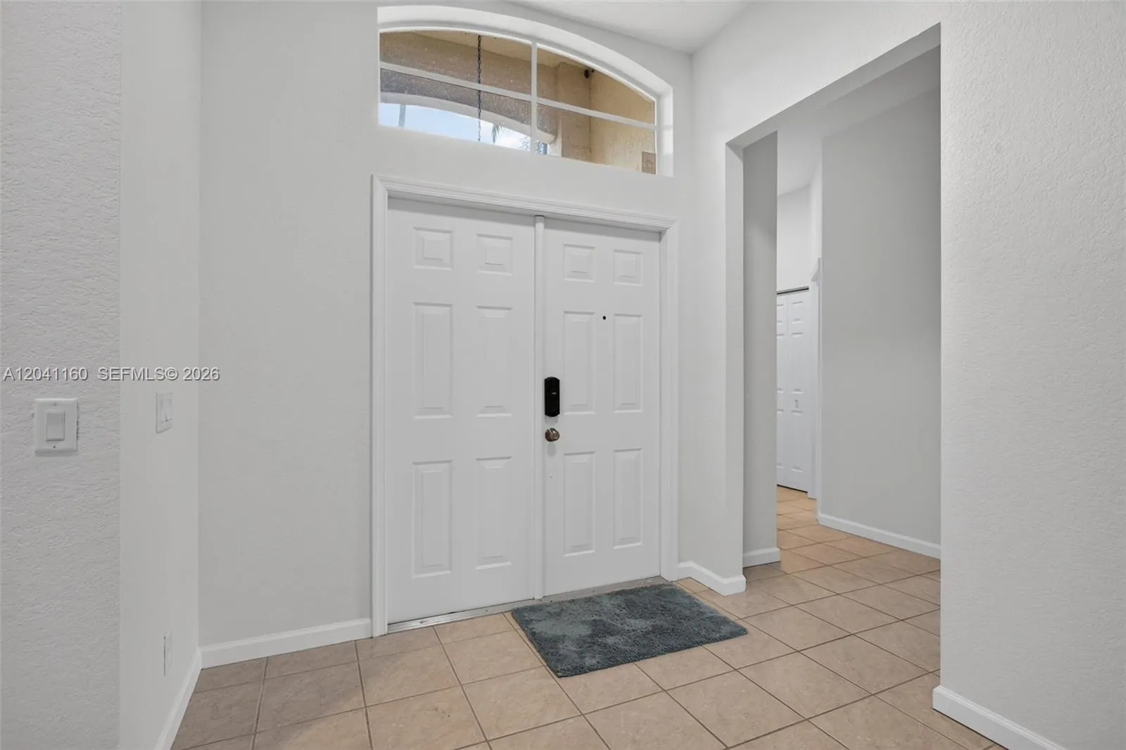 Double entry doors with large transom window to let in natural light.