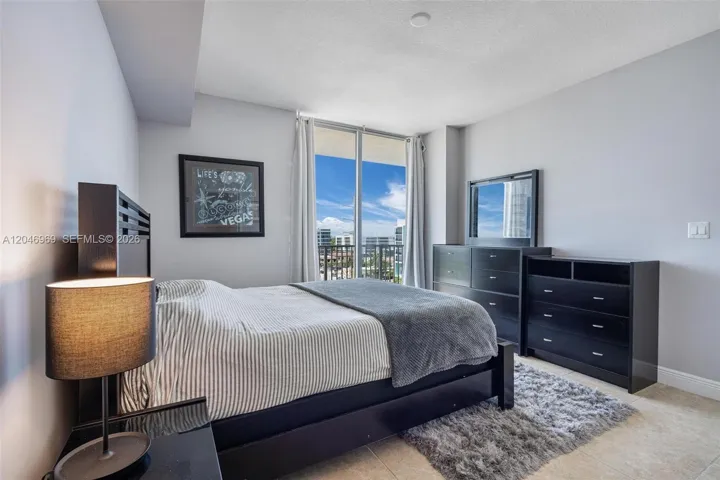 PRIMARY BEDROOM has walk in closet, en suite bathroom with shower/tub combo and its own exit to balcony