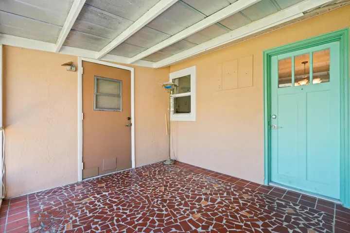 Screened patio. Turquoise Door is back door entry to left side unit. Brown door is to joined laundry area.