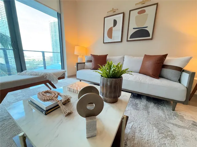 Floor-to-ceiling sliding glass door, neutral wall finishes, and integrated wall sconce lighting