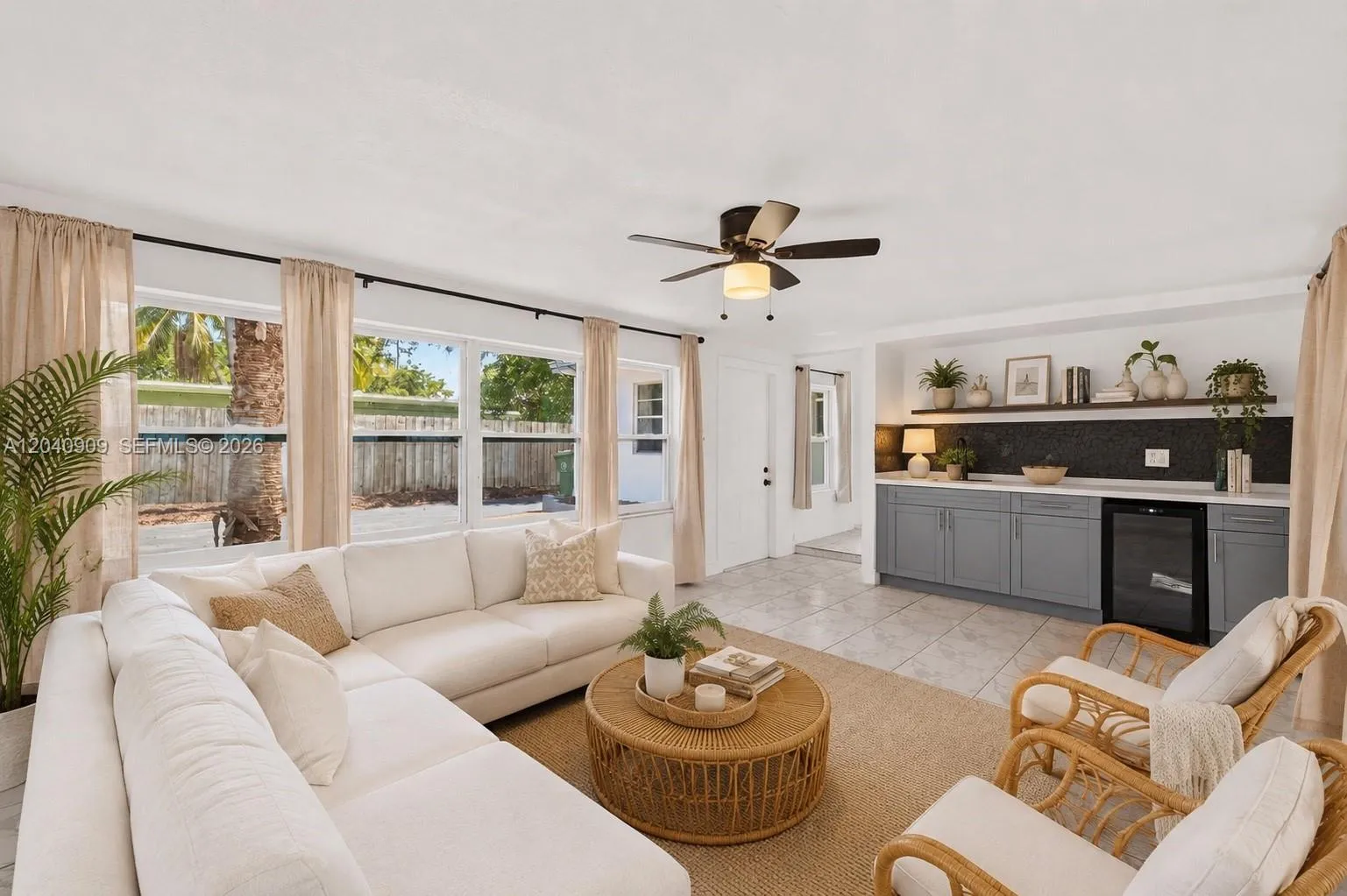 Den separates the primary bedroom from the rest of the house. To the left is a door leading to the side yard and to the pool. Straight down the hall up the step is the kitchen. Image digitally enhanced. AI used for staging purposes