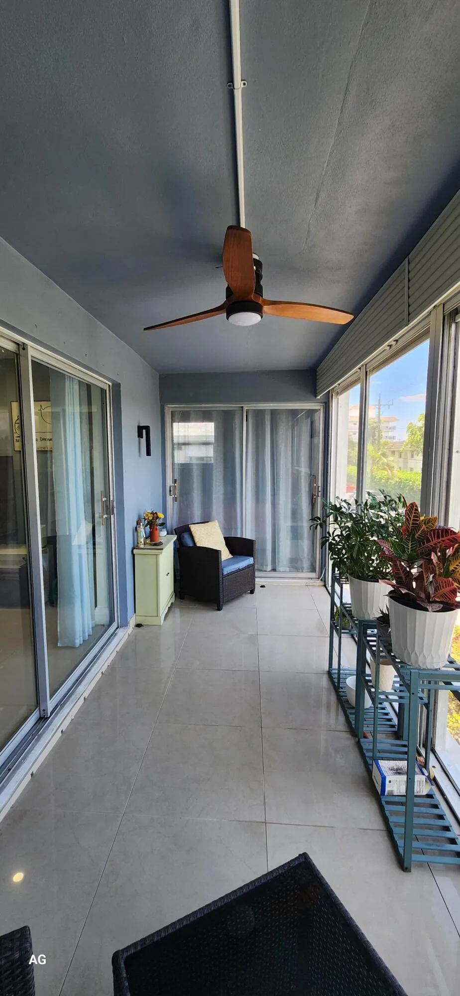 Screened in - tiled patio with rolldown hurricane shutters