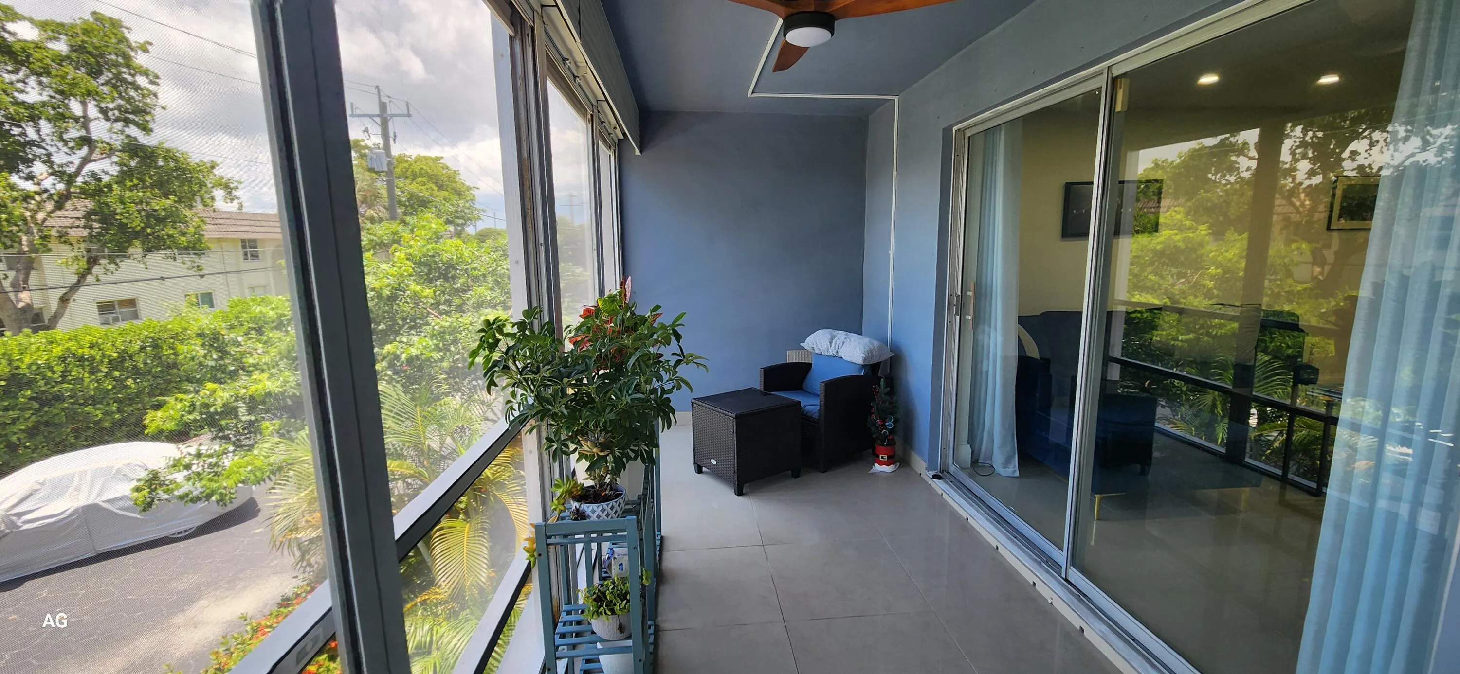Patio View from bedroom- Screened in - tiled patio with rolldown hurricane shutters