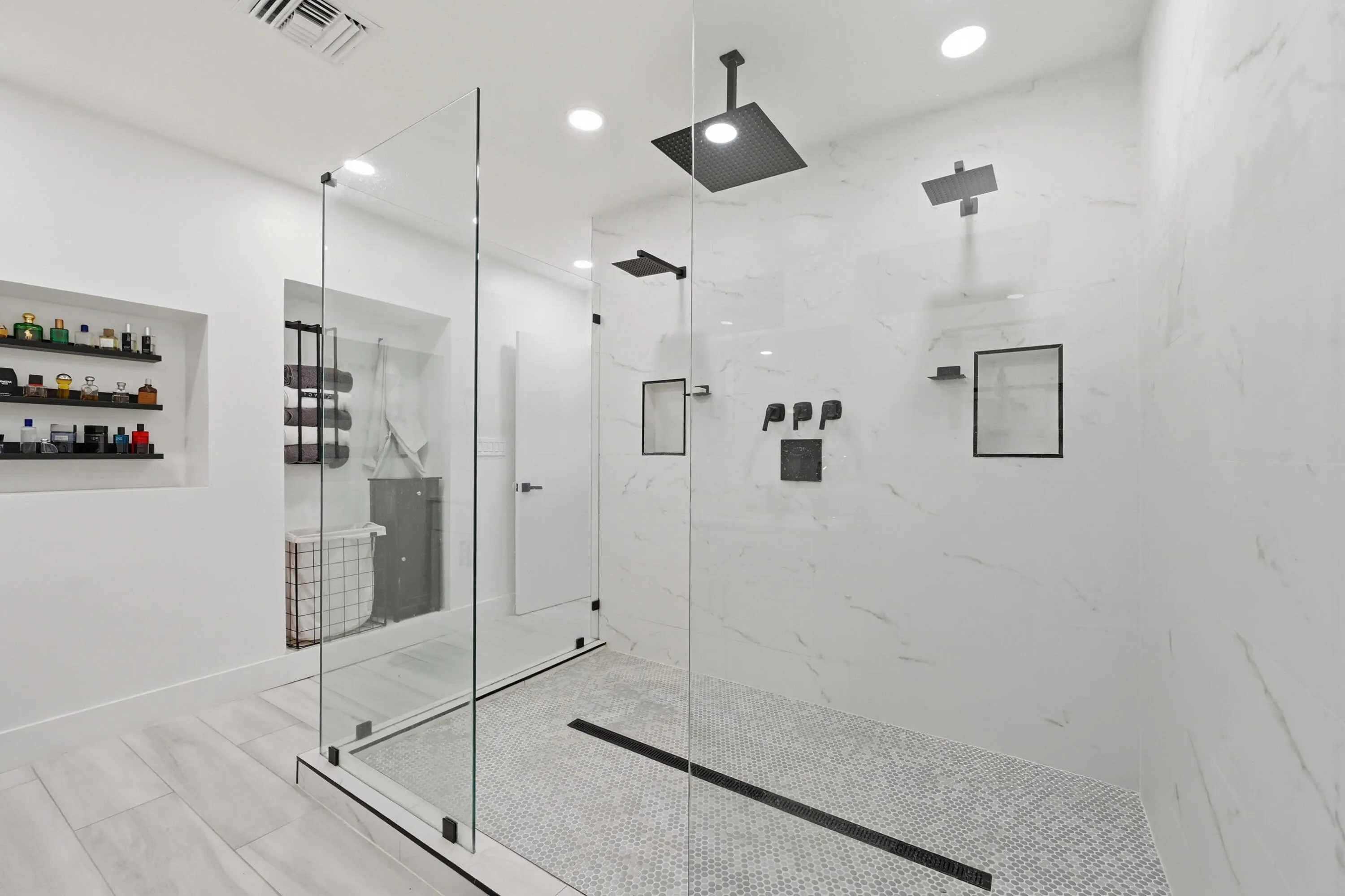 Spa inspired shower featuring multiple shower heads, including a luxurious rain shower for a truly relaxing experience.