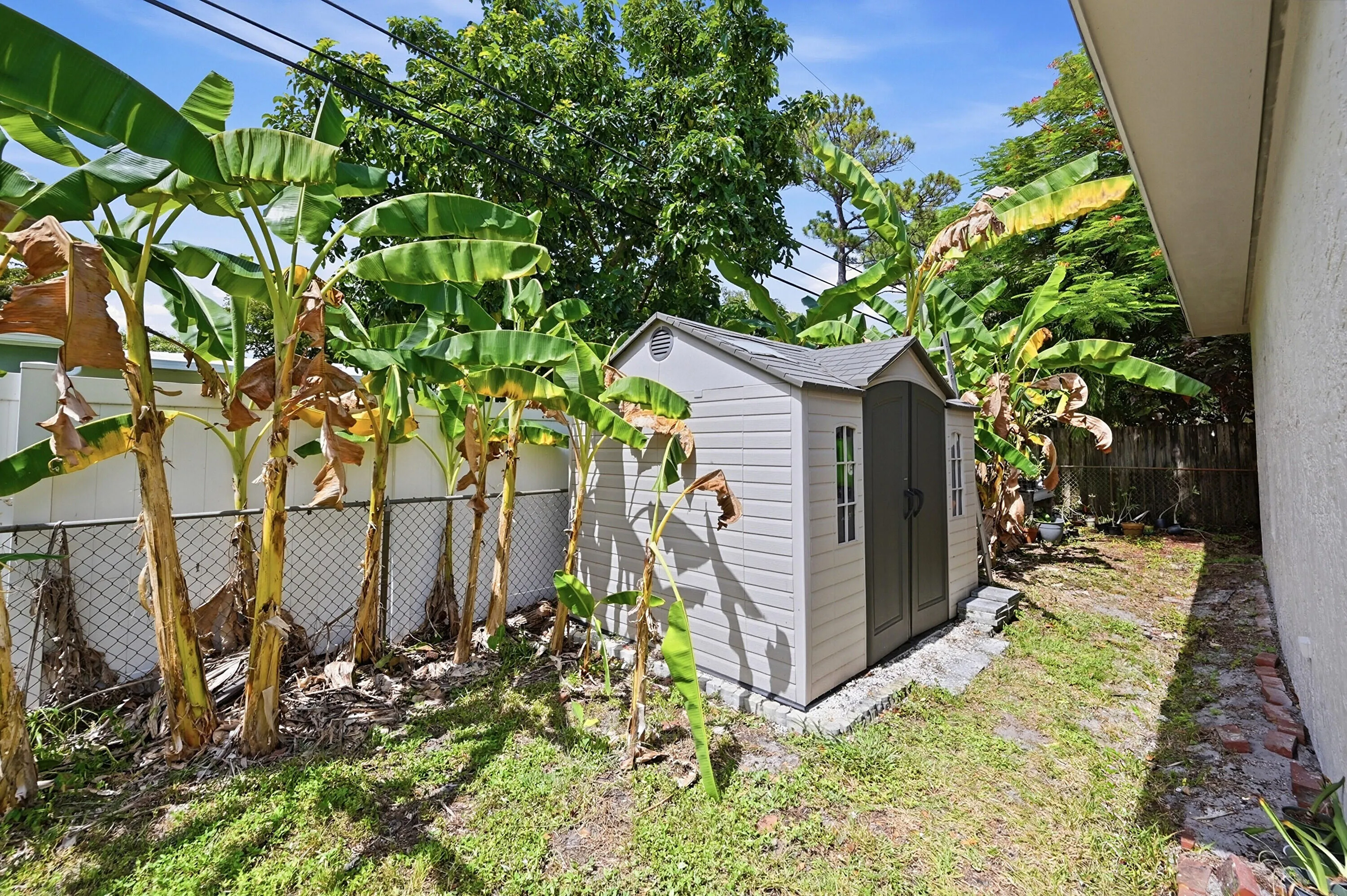 Backyard storage shed provides added convenience and extra space for tools, hobbies, and outdoor equipment.