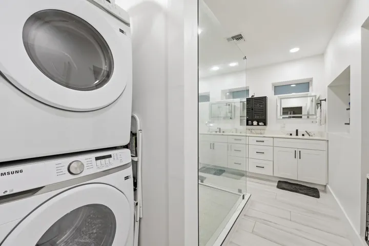 Beautifully renovated primary bathroom with full sized washer and dryer for added everyday convenience.