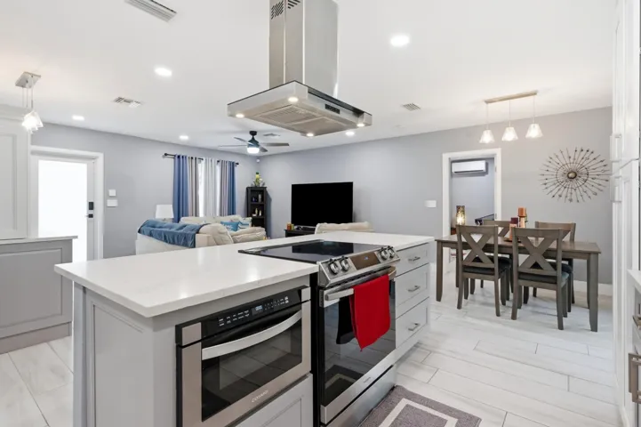 Large island, bar, and beverage cooler create the perfect gathering space for family and friends.