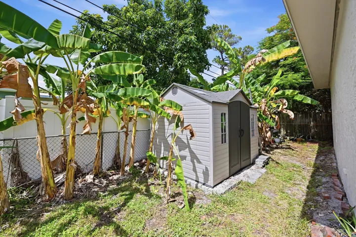 Backyard storage shed provides added convenience and extra space for tools, hobbies, and outdoor equipment.