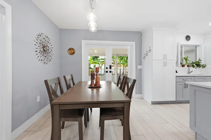 The dining area seamlessly connects the kitchen and screened patio, creating an inviting space for everyday living and entertaining.