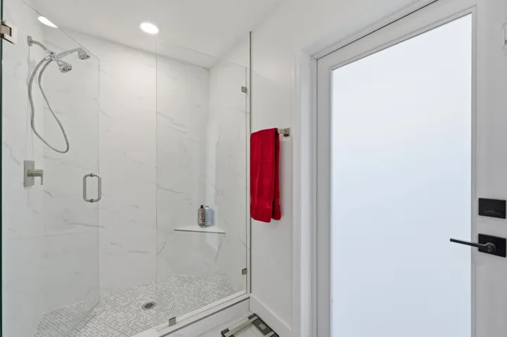Beautifully renovated private bathroom completes the second primary suite with style and comfort.