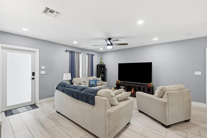 The inviting living room is enhanced by new recessed lighting, adding warmth, style, and a modern touch throughout the home.