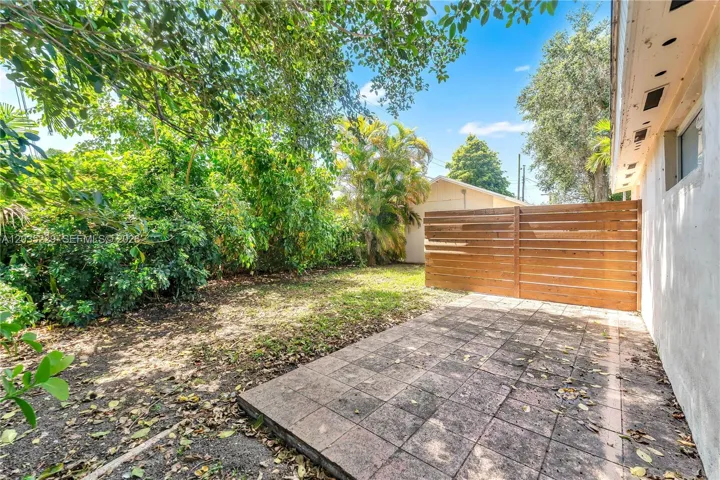 Back of structure with plenty of backyard space.