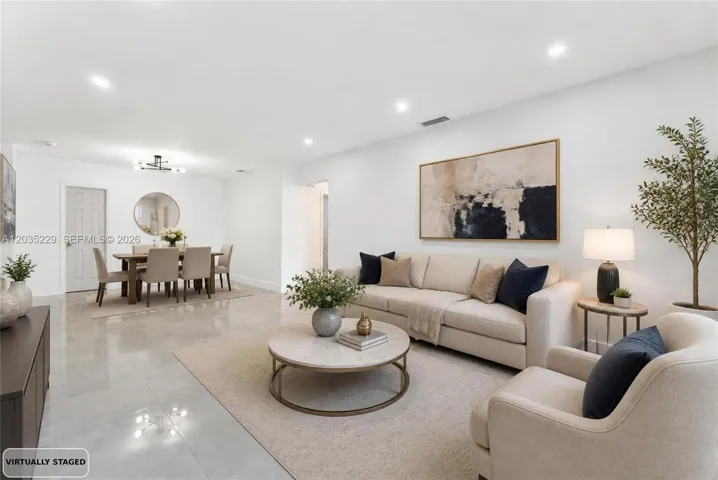 Virtually staged living room and dining area showcasing the open-concept layout.