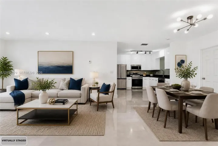 Virtually staged open-concept living, dining, and kitchen area showcasing the home's spacious layout.