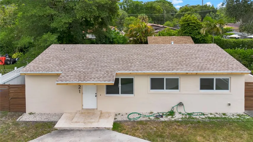 Front aerial view highlighting the home's new roof and updated exterior.