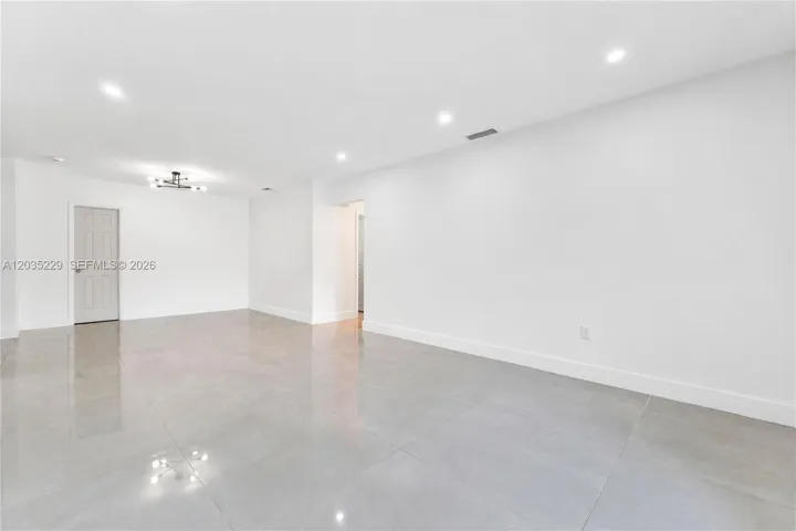 Spacious open-concept living area with recessed lighting.