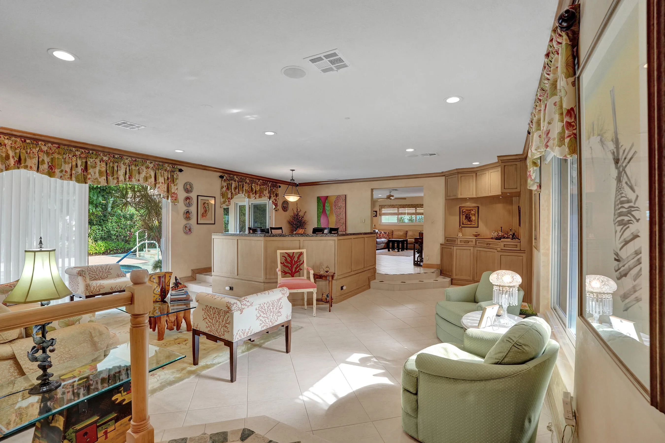 Open living room and dining area. Family, dining, breakfast nook toward the back right of the photo.