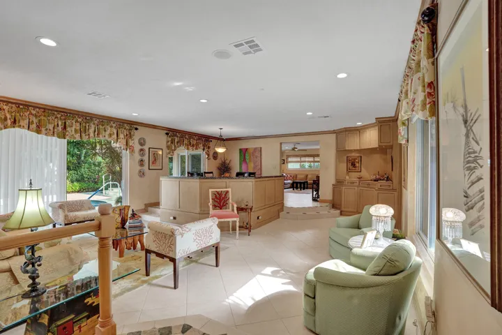 Open living room and dining area. Family, dining, breakfast nook toward the back right of the photo.