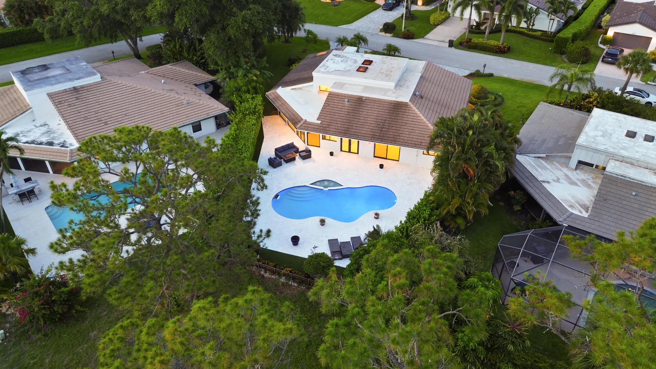 As the sun sets, this remarkable backyard transforms into a private evening retreat where luxury and nature exist in perfect harmony. Backing to a protected nature preserve, the illuminated pool and spa create a stunning focal point, while the peaceful surroundings and complete privacy offer a sense of tranquility rarely found in South Florida. Whether hosting an elegant evening under the stars or unwinding after a long day, this extraordinary outdoor oasis delivers a resort inspired lifestyle that feels worlds away, yet is just minutes from everything Delray Beach has to offer.