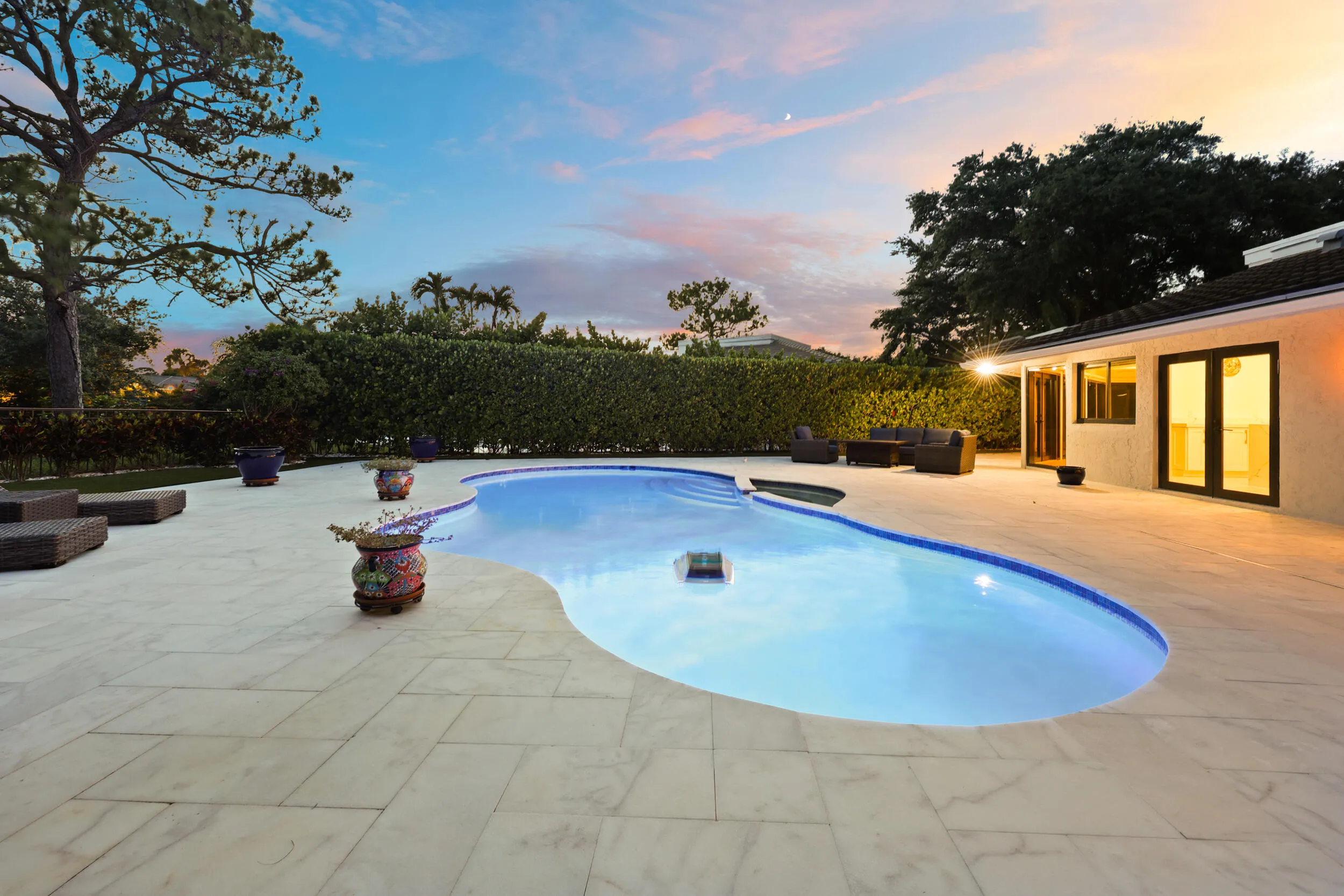 As the sun sets, this remarkable backyard transforms into a private evening retreat where luxury and nature exist in perfect harmony. Backing to a protected nature preserve, the illuminated pool and spa create a stunning focal point, while the peaceful surroundings and complete privacy offer a sense of tranquility rarely found in South Florida. Whether hosting an elegant evening under the stars or unwinding after a long day, this extraordinary outdoor oasis delivers a resort inspired lifestyle that feels worlds away, yet is just minutes from everything Delray Beach has to offer.