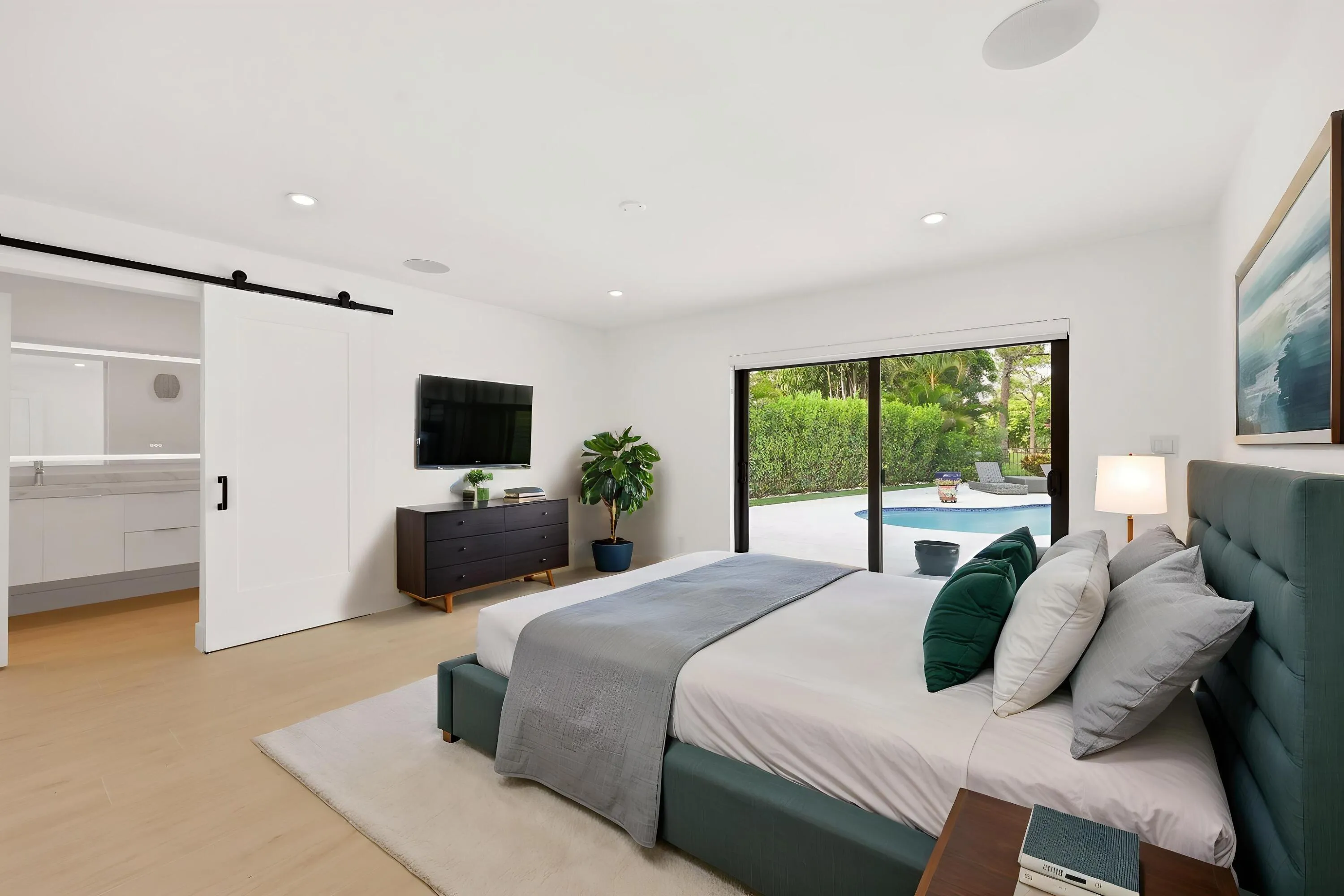 Designed as a true private guest retreat, this spacious suite offers exceptional comfort, privacy, and direct access to the backyard through oversized hurricane impact sliding glass doors. A massive custom closet and beautifully renovated ensuite bathroom provide the feel of a luxury hotel suite, while just outside your door, the pool, outdoor shower, and peaceful preserve setting create a secluded oasis for family and guests alike. Thoughtfully positioned away from the main living areas, this inviting space delivers both independence and tranquility.