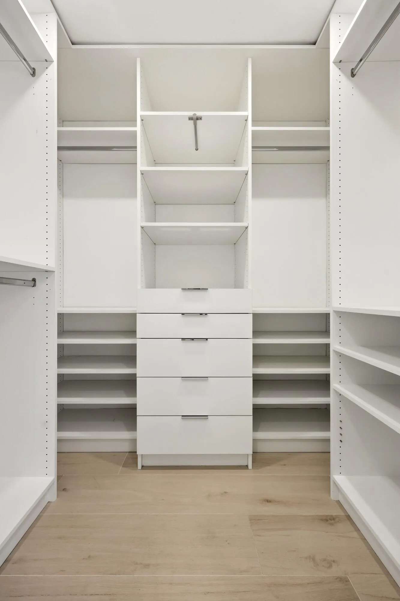 The custom walk-in closet is thoughtfully designed with extensive built-in storage, adjustable shelving, multiple hanging areas, and dedicated drawer space to keep everything organized and easily accessible. Bright, spacious, and highly functional, it provides the perfect complement to the luxurious primary suite.