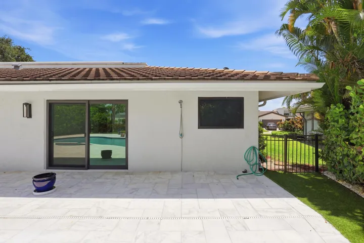 A private outdoor shower adds both convenience and a touch of resort style luxury, offering the perfect place to rinse off after a refreshing swim or simply enjoy the peaceful surroundings of this secluded backyard retreat.
