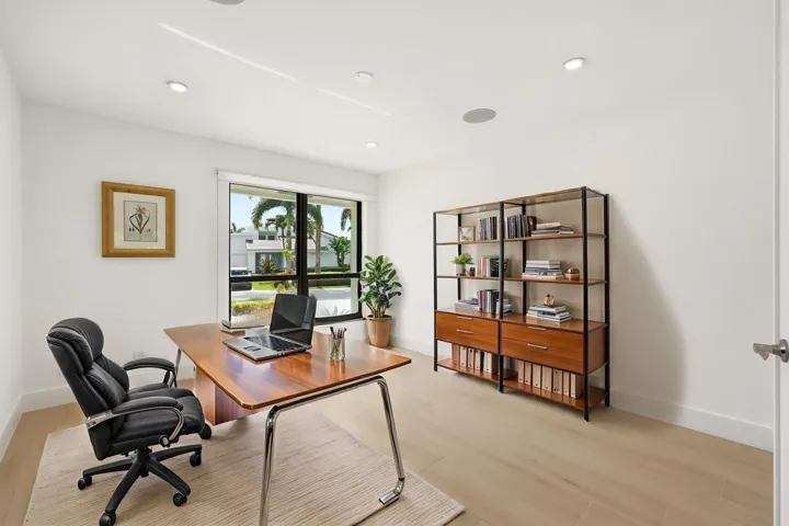 Currently configured as a sophisticated home office, this bright and versatile room easily adapts to fit your lifestyle as a guest bedroom, den, or creative workspace. Hurricane impact windows fill the space with natural light, while generous closet space and its convenient location near the beautifully renovated guest bathroom make it as functional as it is inviting.