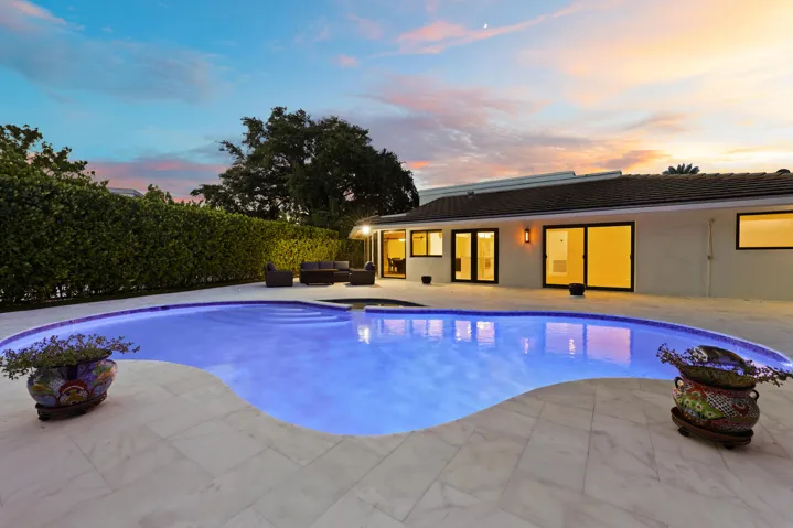 As the sun sets, this remarkable backyard transforms into a private evening retreat where luxury and nature exist in perfect harmony. Backing to a protected nature preserve, the illuminated pool and spa create a stunning focal point, while the peaceful surroundings and complete privacy offer a sense of tranquility rarely found in South Florida. Whether hosting an elegant evening under the stars or unwinding after a long day, this extraordinary outdoor oasis delivers a resort inspired lifestyle that feels worlds away, yet is just minutes from everything Delray Beach has to offer.