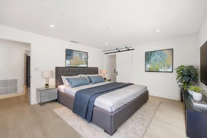 Designed as a true private guest retreat, this spacious suite offers exceptional comfort, privacy, and direct access to the backyard through oversized hurricane impact sliding glass doors. A massive custom closet and beautifully renovated ensuite bathroom provide the feel of a luxury hotel suite, while just outside your door, the pool, outdoor shower, and peaceful preserve setting create a secluded oasis for family and guests alike. Thoughtfully positioned away from the main living areas, this inviting space delivers both independence and tranquility.