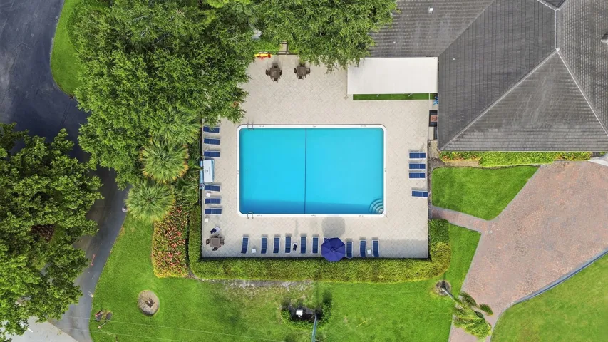 Relax and unwind at the resort style pool, surrounded by lush tropical landscaping and just steps from the Seagate Country Club clubhouse.