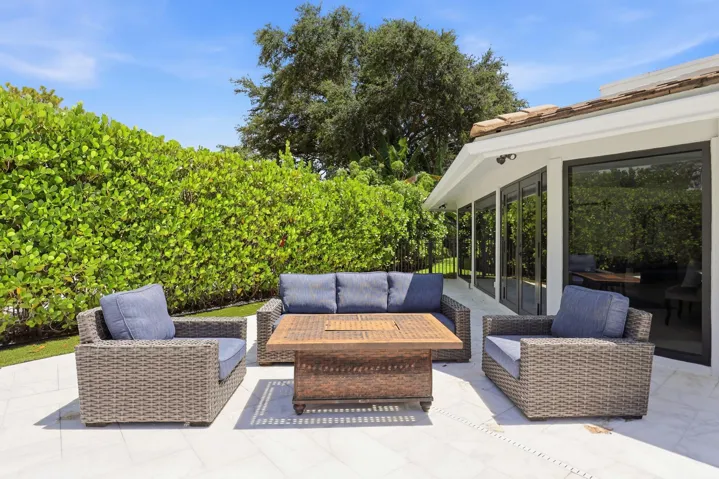 Discover your own private backyard sanctuary where modern luxury meets the natural beauty of Old Florida. Backing directly to a nature preserve, this extraordinary outdoor retreat offers a level of privacy rarely found in South Florida, creating a peaceful setting with no rear neighbors and lush tropical views in every direction. A newly renovated freeform pool and spa are surrounded by an expansive marble pool deck, offering the perfect backdrop for relaxing afternoons or effortless entertaining.Thoughtfully designed as an extension of the home, the backyard features multiple spaces to lounge, dine, and gather, all immersed in the serenity of the surrounding preserve. Whether enjoying your morning coffee, an evening swim, or hosting friends and family, every moment is enhanced by the tranquil landscape and exceptional sense of seclusion that defines this remarkable property.