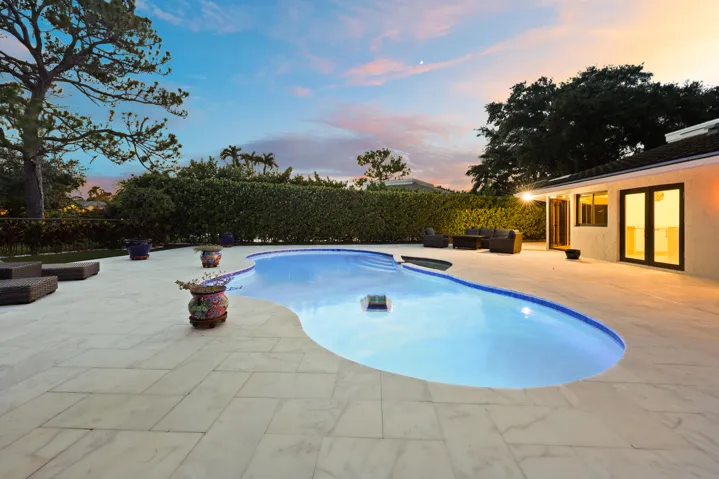 As the sun sets, this remarkable backyard transforms into a private evening retreat where luxury and nature exist in perfect harmony. Backing to a protected nature preserve, the illuminated pool and spa create a stunning focal point, while the peaceful surroundings and complete privacy offer a sense of tranquility rarely found in South Florida. Whether hosting an elegant evening under the stars or unwinding after a long day, this extraordinary outdoor oasis delivers a resort inspired lifestyle that feels worlds away, yet is just minutes from everything Delray Beach has to offer.