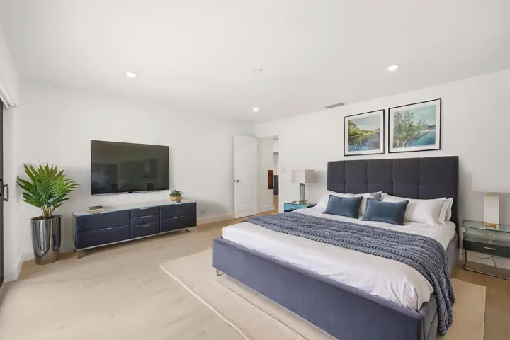 Designed as a true private guest retreat, this spacious suite offers exceptional comfort, privacy, and direct access to the backyard through oversized hurricane impact sliding glass doors. A massive custom closet and beautifully renovated ensuite bathroom provide the feel of a luxury hotel suite, while just outside your door, the pool, outdoor shower, and peaceful preserve setting create a secluded oasis for family and guests alike. Thoughtfully positioned away from the main living areas, this inviting space delivers both independence and tranquility.