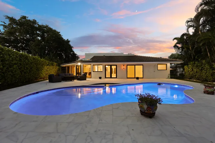 As the sun sets, this remarkable backyard transforms into a private evening retreat where luxury and nature exist in perfect harmony. Backing to a protected nature preserve, the illuminated pool and spa create a stunning focal point, while the peaceful surroundings and complete privacy offer a sense of tranquility rarely found in South Florida. Whether hosting an elegant evening under the stars or unwinding after a long day, this extraordinary outdoor oasis delivers a resort inspired lifestyle that feels worlds away, yet is just minutes from everything Delray Beach has to offer.