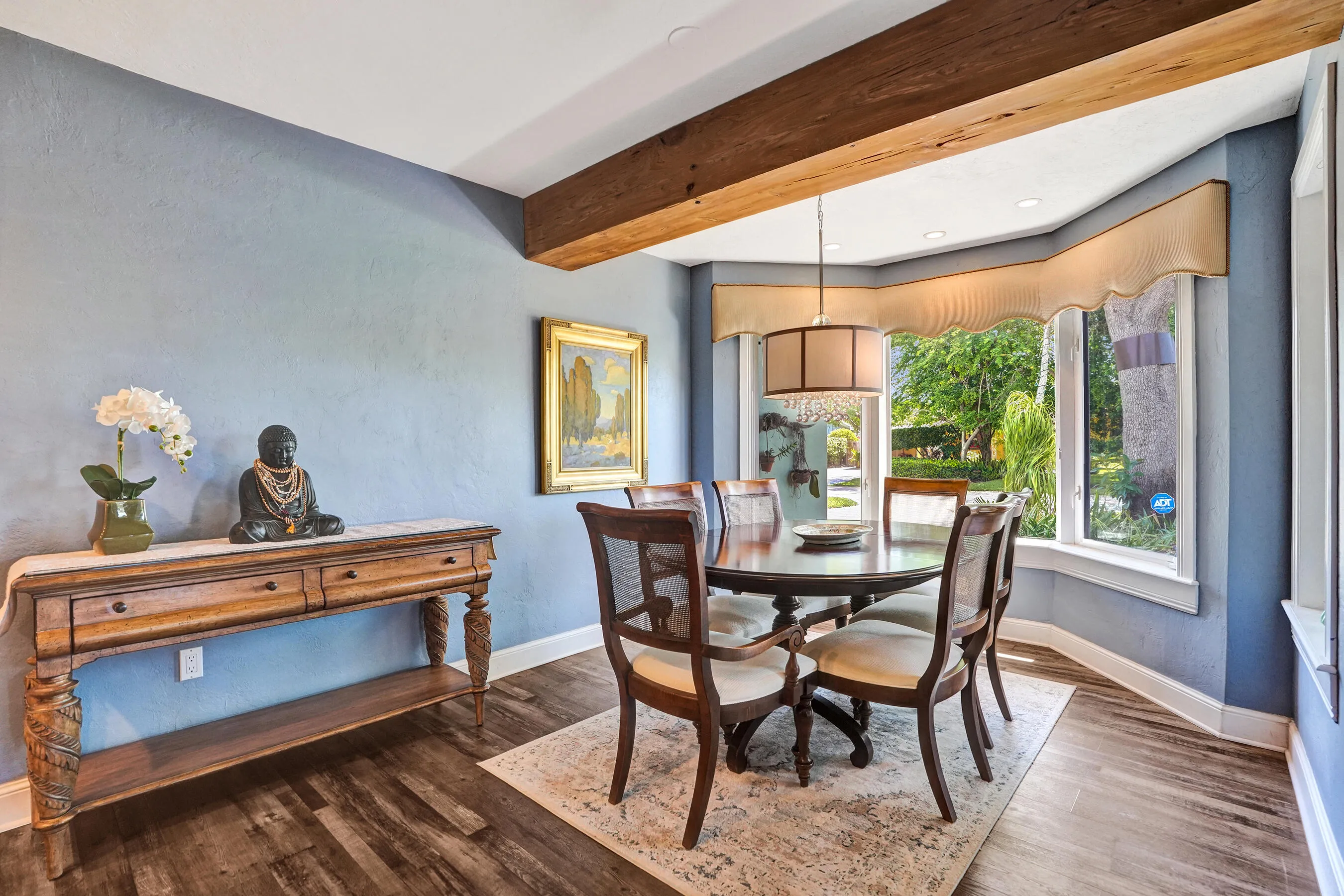 Open dining area adjacent to the chef's kitchen with bay window seating, ideal for everyday living and entertaining.