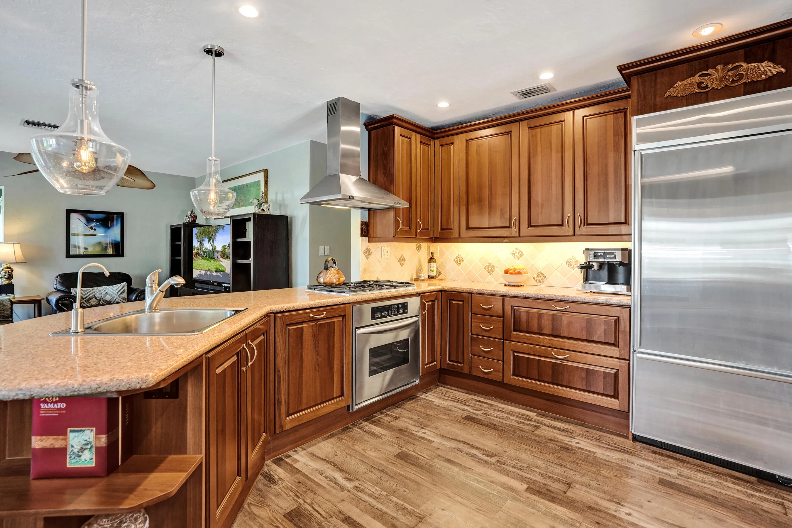 NKBA-designed chef's kitchen featuring ARAN Italian cabinetry, Silestone quartz countertops from Spain, KitchenAid Professional Series stainless appliances, natural gas cooktop, Bosch paneled dishwasher, walk-in pantry, and spacious eat-in peninsula.
