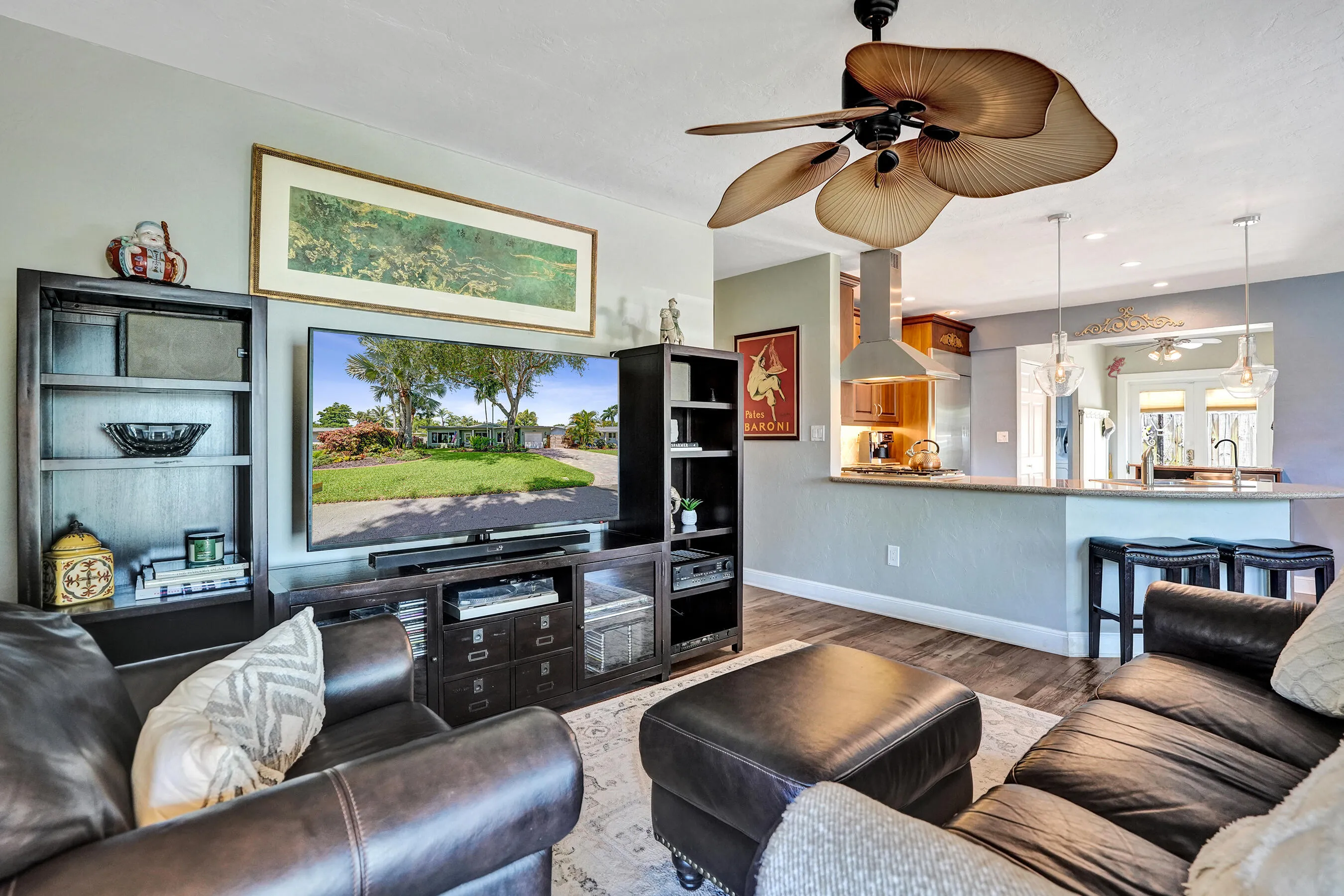 Warm, inviting living space showcasing hand-plastered textured walls, Craftsman-style millwork, luxury vinyl plank flooring, and an open-concept design.