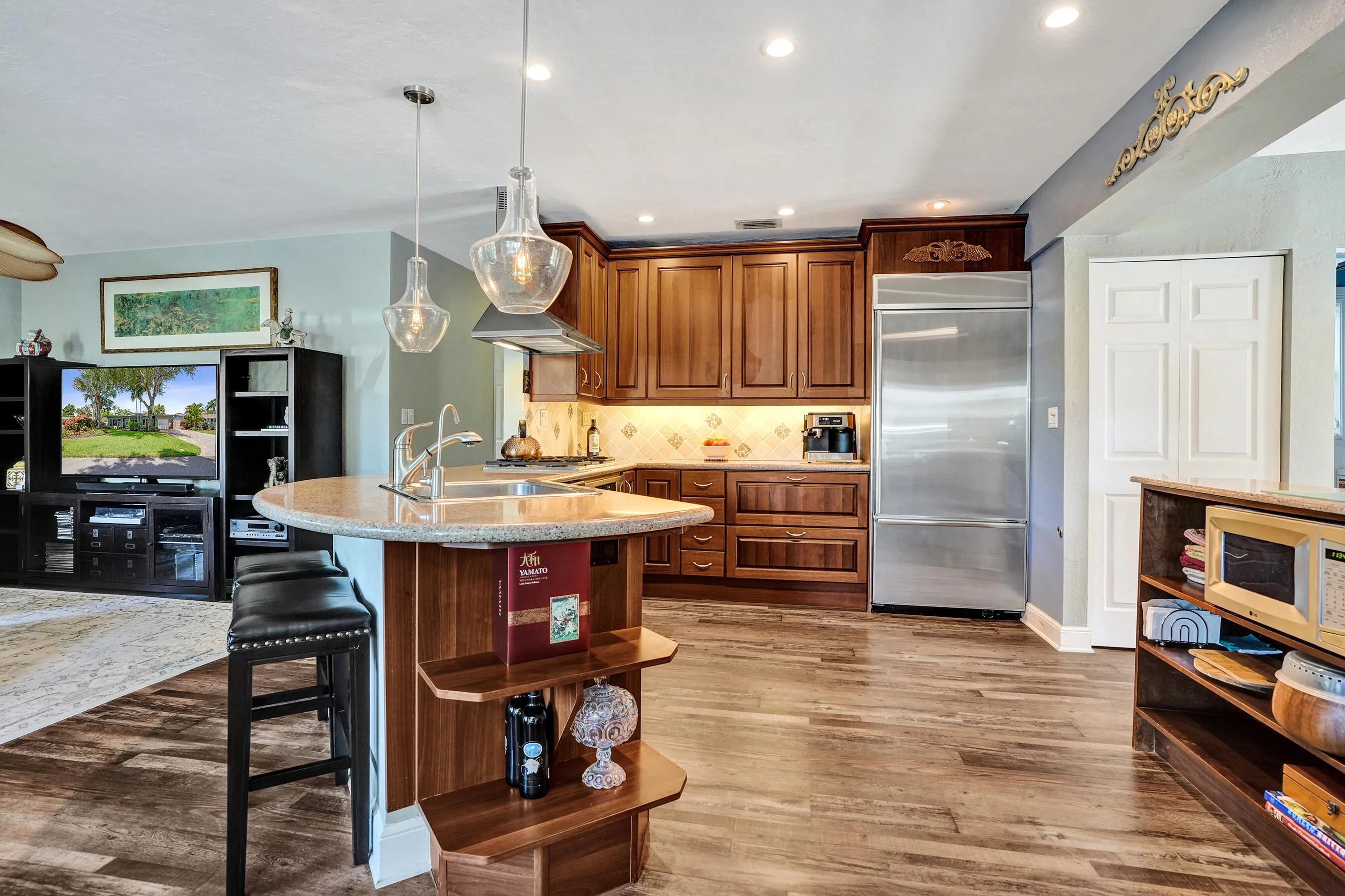 NKBA-designed chef's kitchen featuring ARAN Italian cabinetry, Silestone quartz countertops from Spain, KitchenAid Professional Series stainless appliances, natural gas cooktop, Bosch paneled dishwasher, walk-in pantry, and spacious eat-in peninsula.