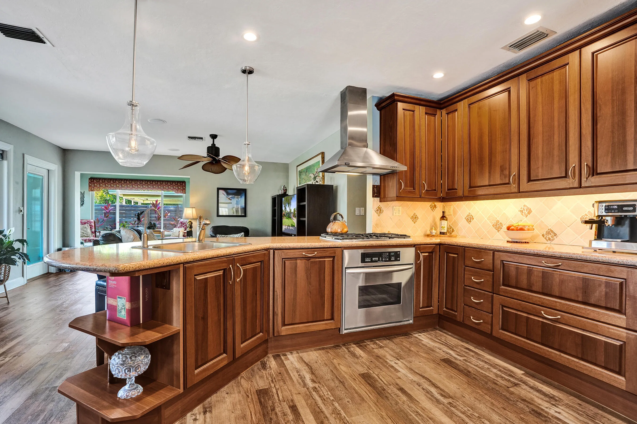 NKBA-designed chef's kitchen featuring ARAN Italian cabinetry, Silestone quartz countertops from Spain, KitchenAid Professional Series stainless appliances, natural gas cooktop, Bosch paneled dishwasher, walk-in pantry, and spacious eat-in peninsula.