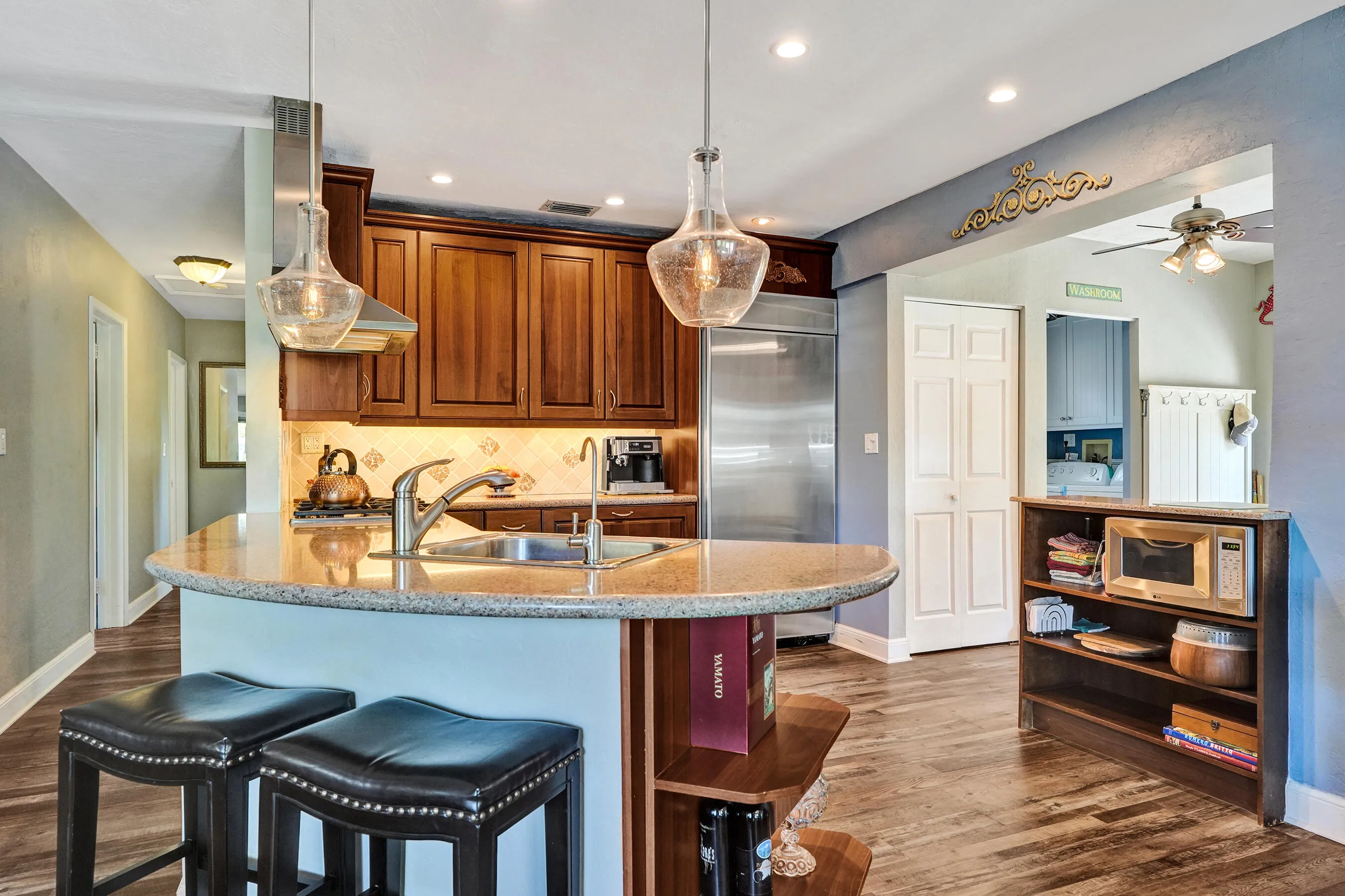NKBA-designed chef's kitchen featuring ARAN Italian cabinetry, Silestone quartz countertops from Spain, KitchenAid Professional Series stainless appliances, natural gas cooktop, Bosch paneled dishwasher, walk-in pantry, and spacious eat-in peninsula.