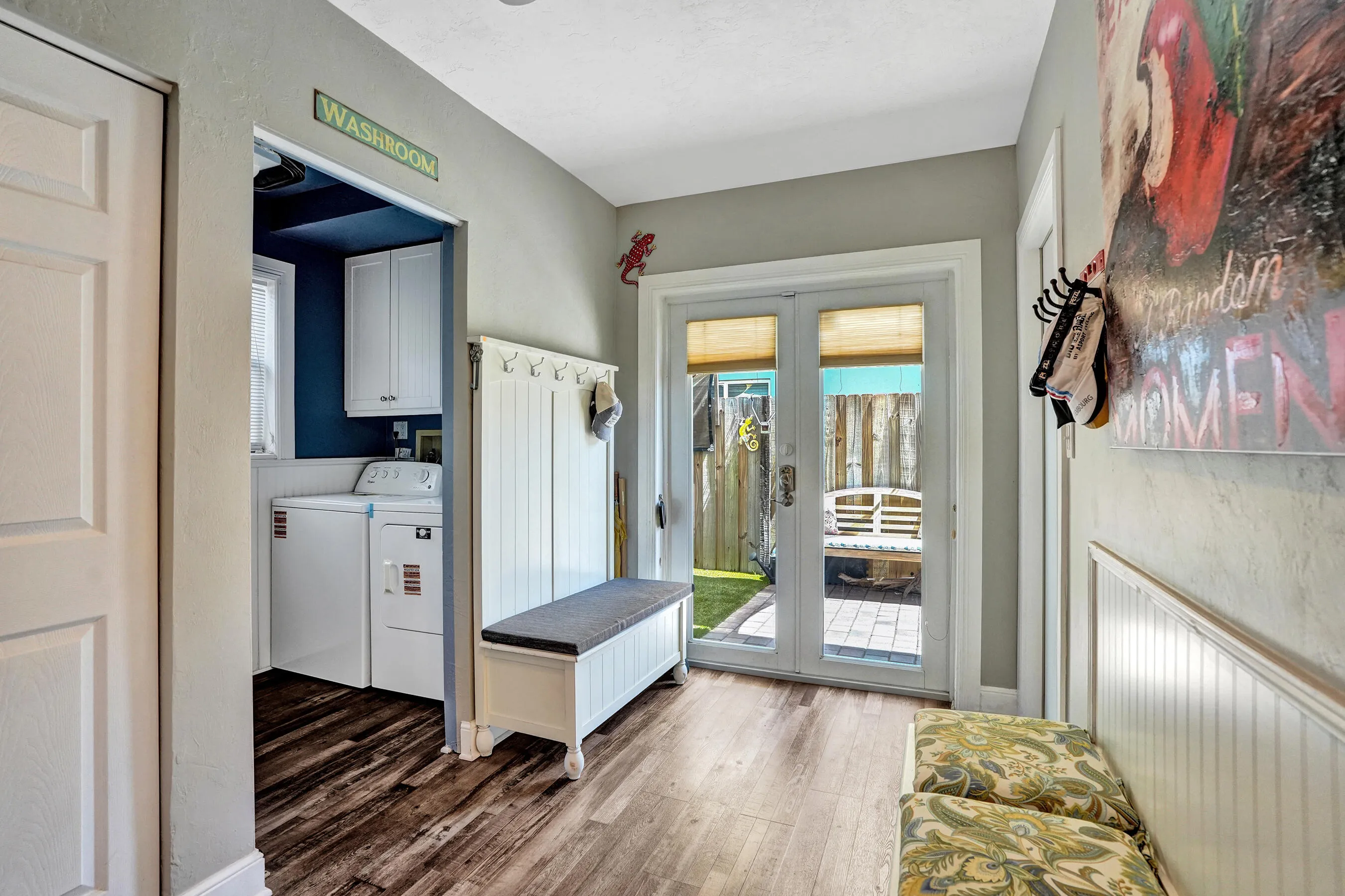Charming breakfast nook with built-in banquet seating, additional hidden storage, and views of the tropical patio.