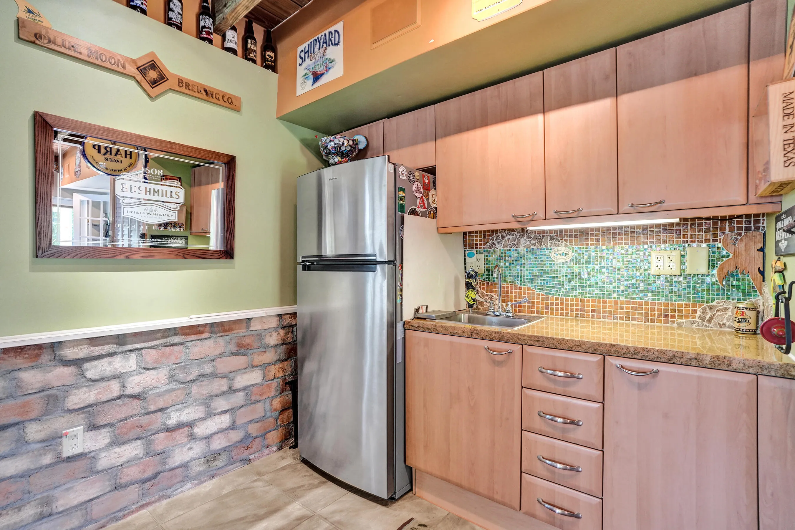 Extraordinary bonus room with tongue-and-groove stained wood ceiling, Chicago brick accents, wet kitchenette, ARAN Italian cabinetry, granite countertops, TV bar, dedicated mini-split A/C, and endless possibilities for media, fitness, or guest accommodations.