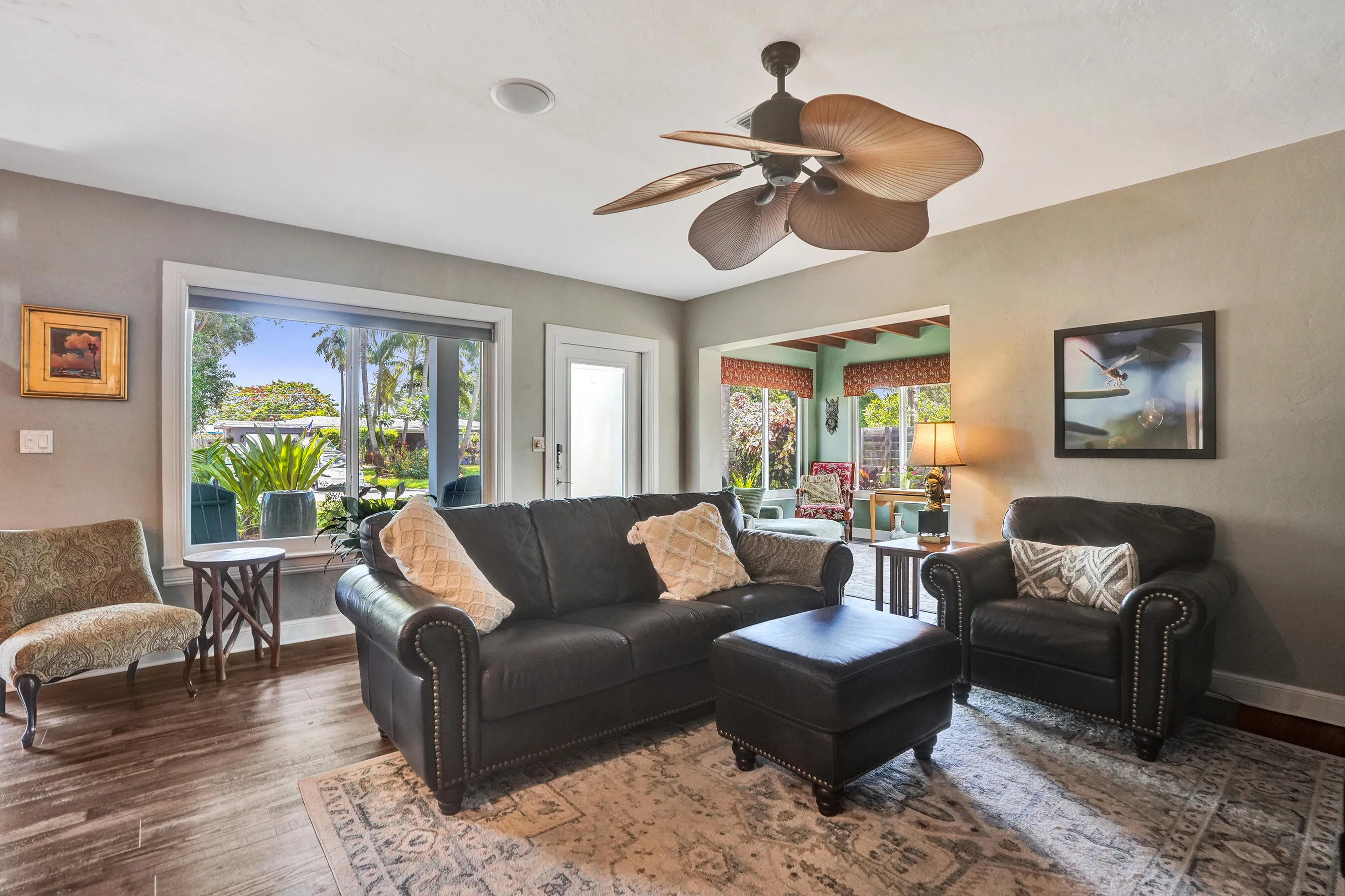 Warm, inviting living space showcasing hand-plastered textured walls, Craftsman-style millwork, luxury vinyl plank flooring, and an open-concept design.