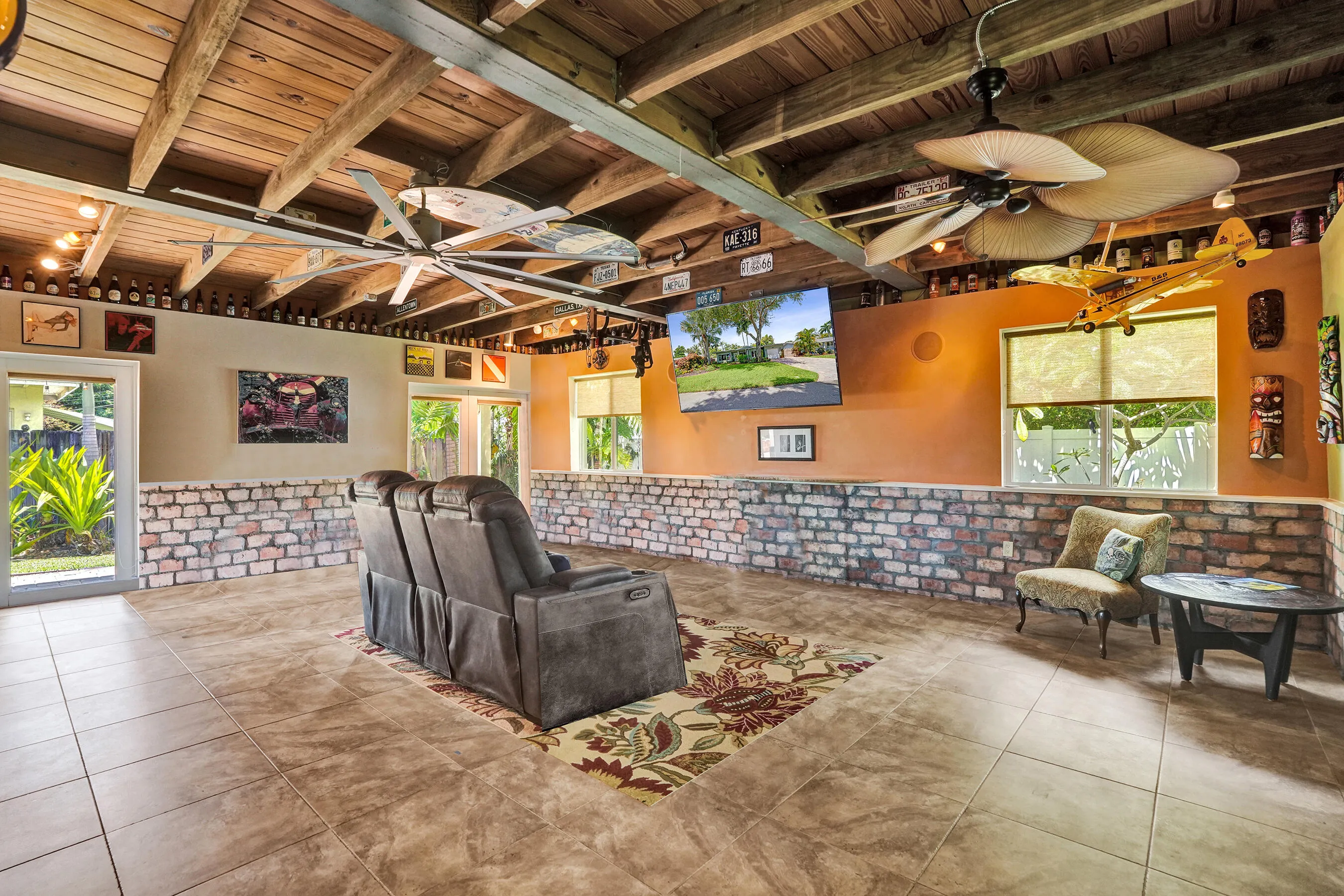 Extraordinary bonus room with tongue-and-groove stained wood ceiling, Chicago brick accents, wet kitchenette, ARAN Italian cabinetry, granite countertops, TV bar, dedicated mini-split A/C, and endless possibilities for media, fitness, or guest accommodations.